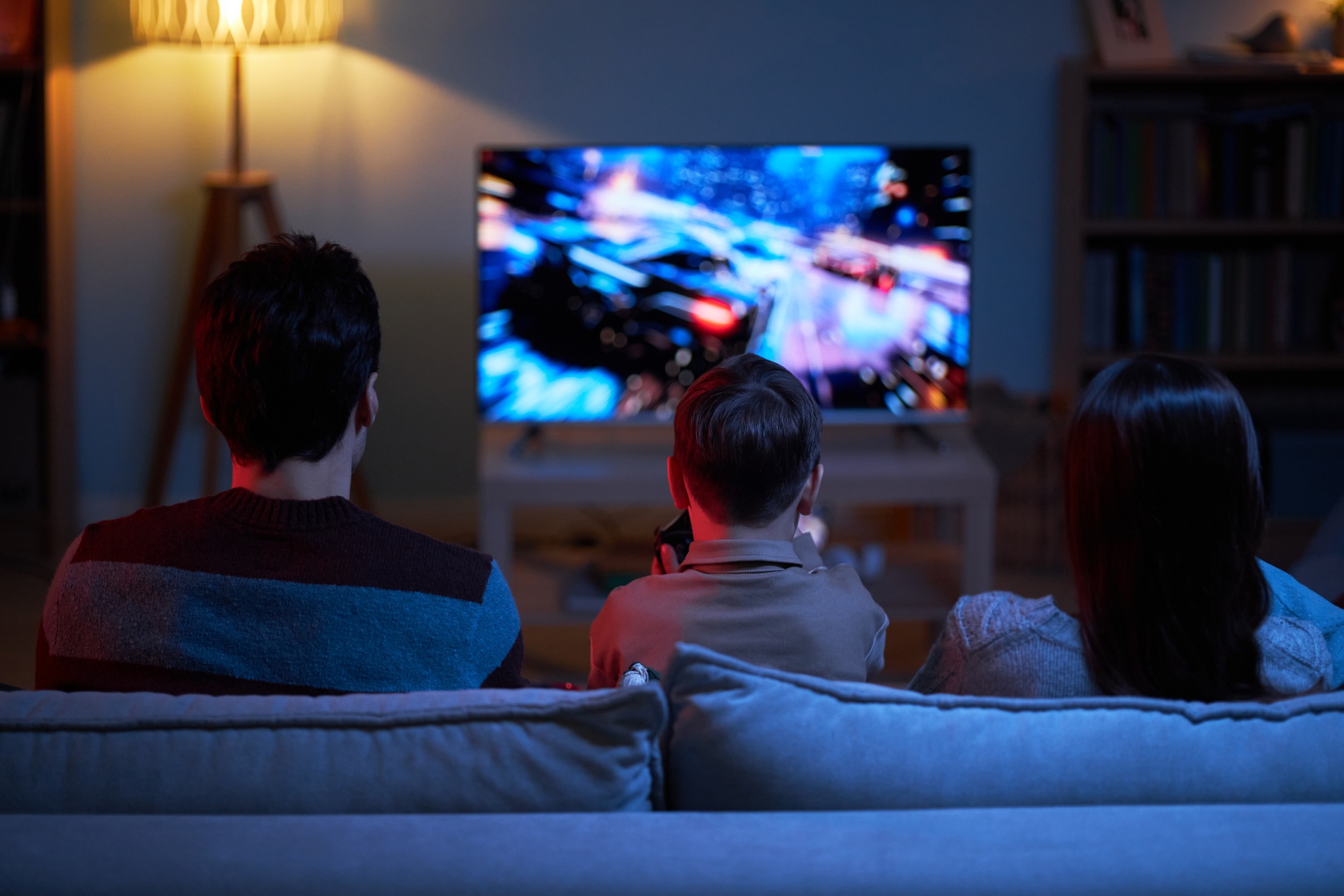 Child Playing Video Game With Parents